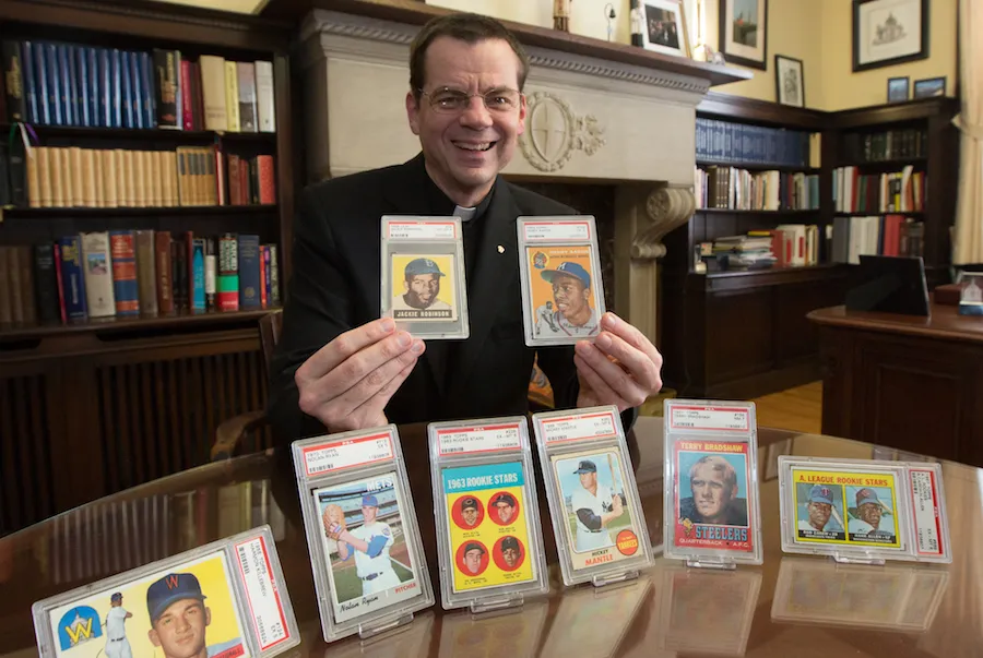 Father Ubel with baseball cards.?w=200&h=150